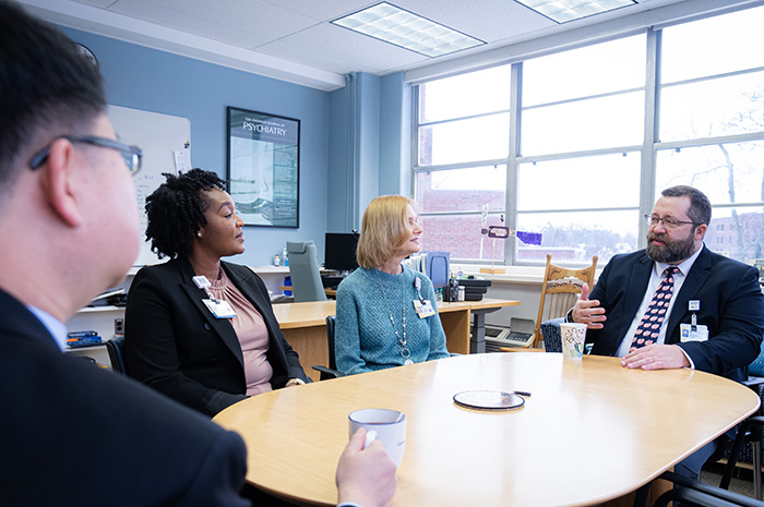 faculty talking around a table