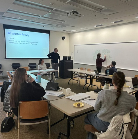 interns in modern classroom watching a women write on the white board