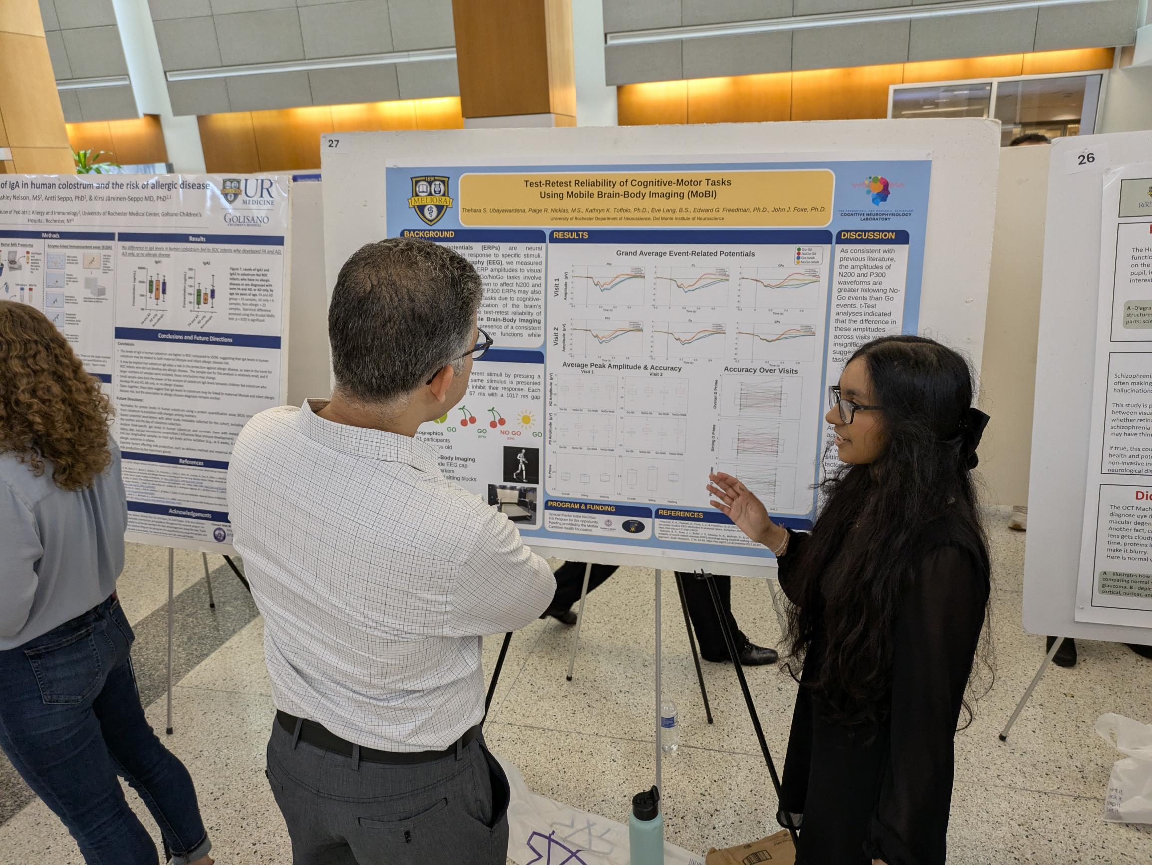 student presents scientific poster