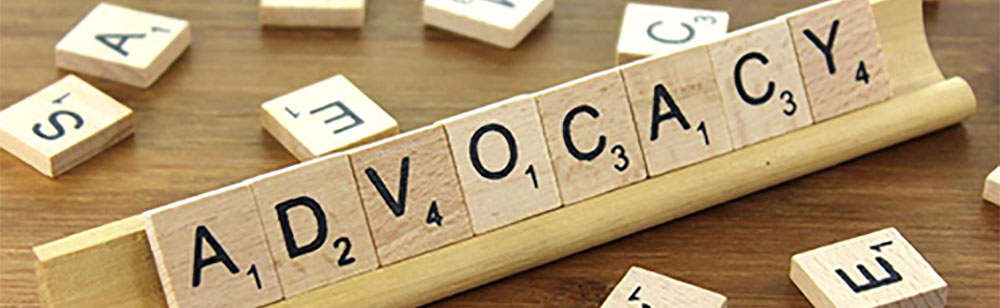 Advocacy spelt out in scrabble tiles on rack