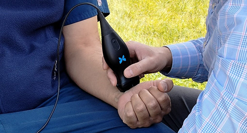 Provider performing an ultrasound of a person's wrist