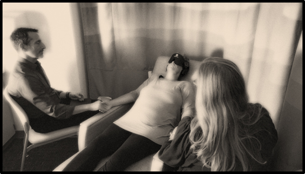 Two facilitators assist a patient at a Pal-KAP session