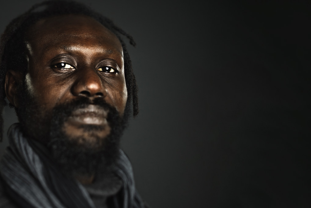 Portrait of an African American man wearing a gray scarf