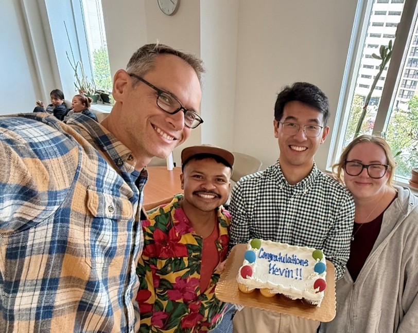 Kevin holding a congratulations cake