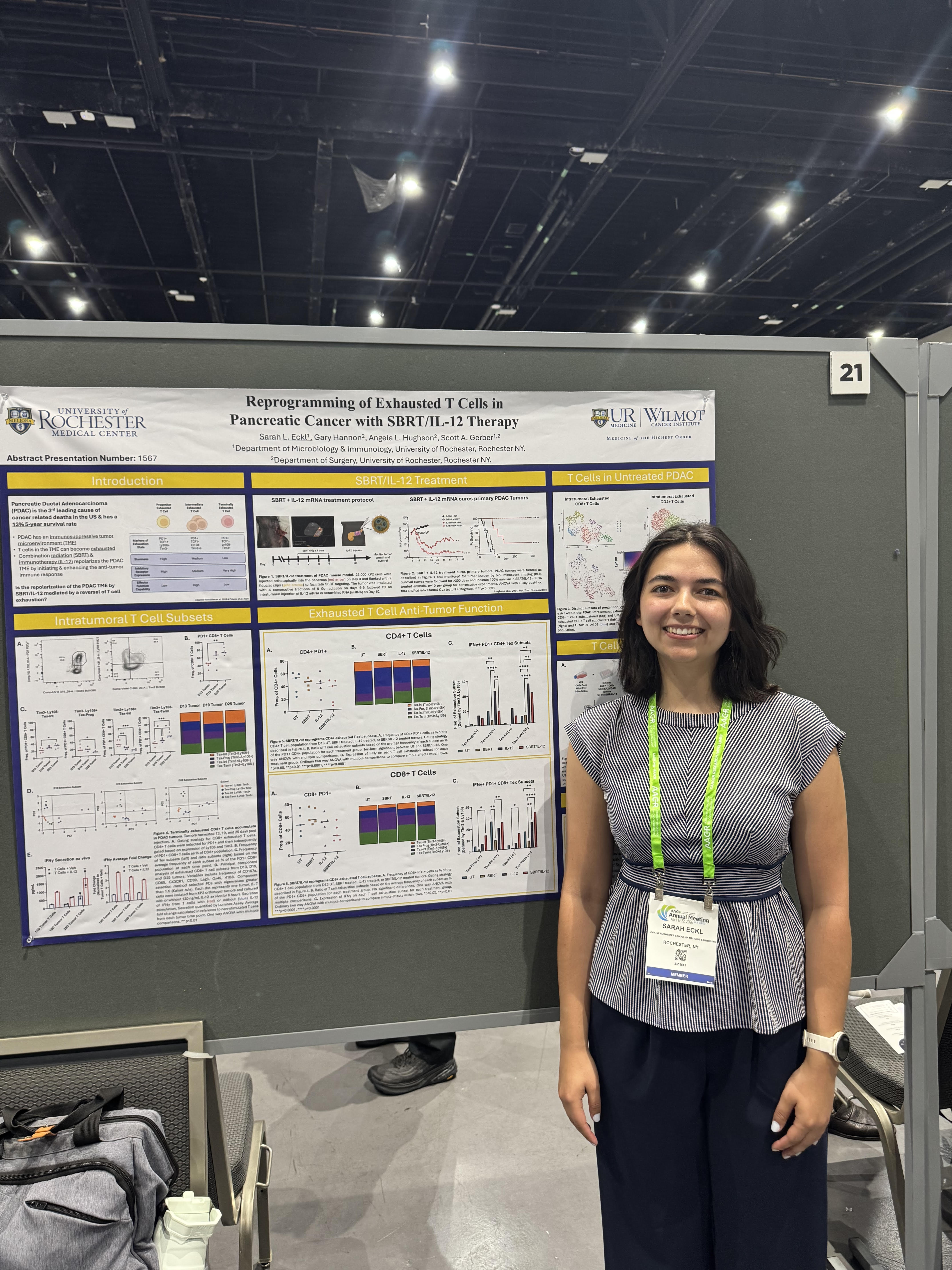 Sarah in front of her poster at the event