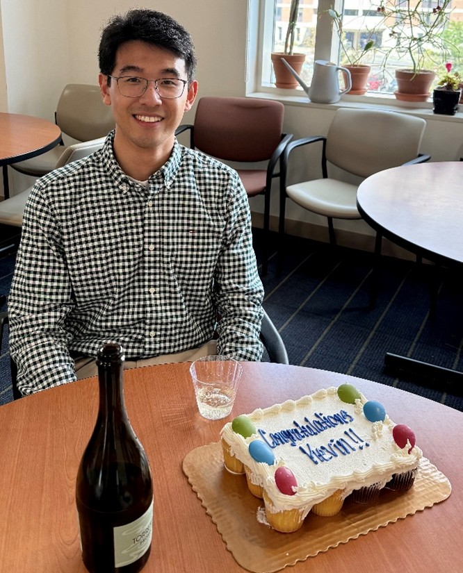 Kevin sitting at a table with his cake on it