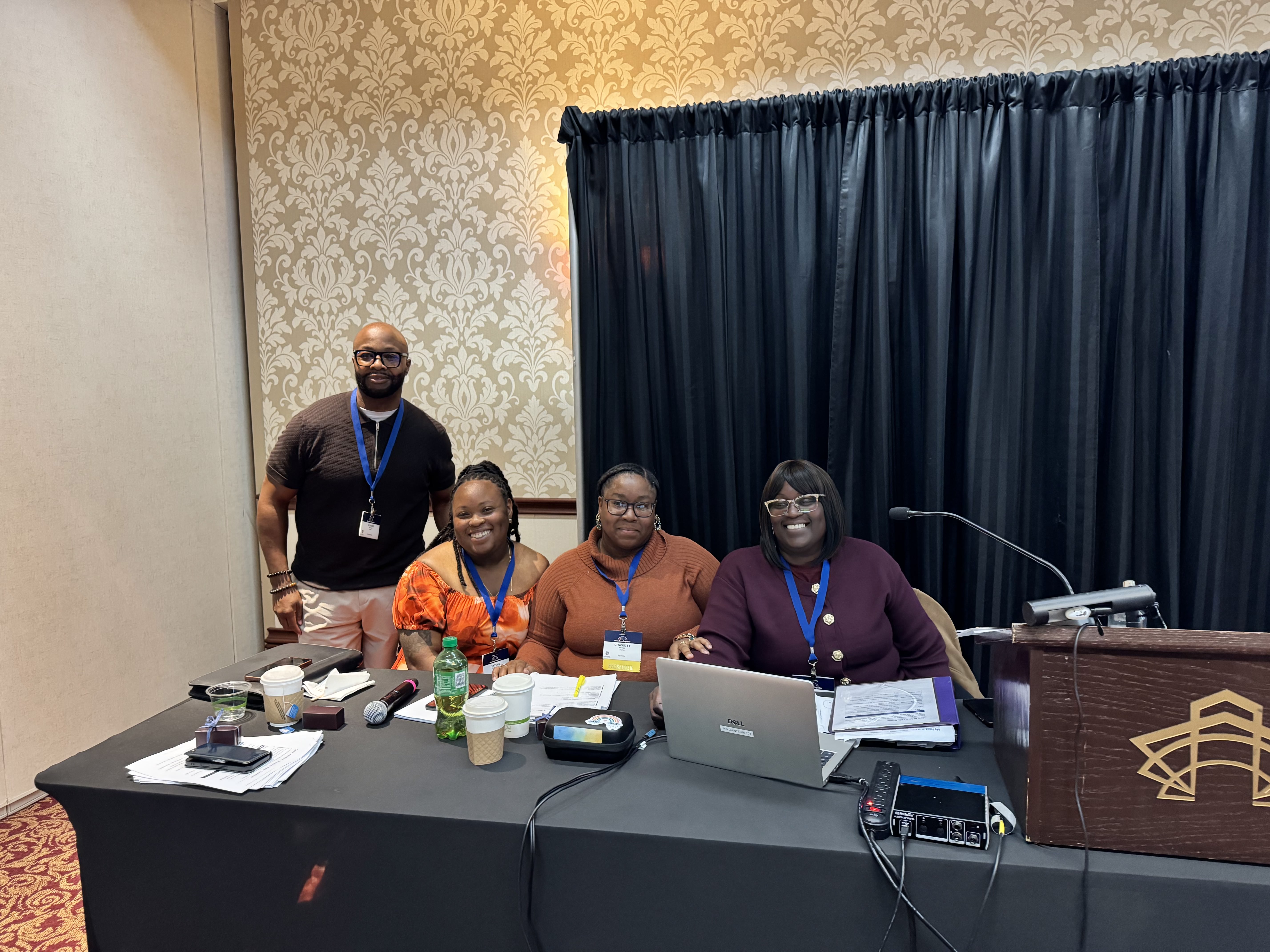 Pediatric Behavioral Health and Wellness team members smiling and sitting at a team member