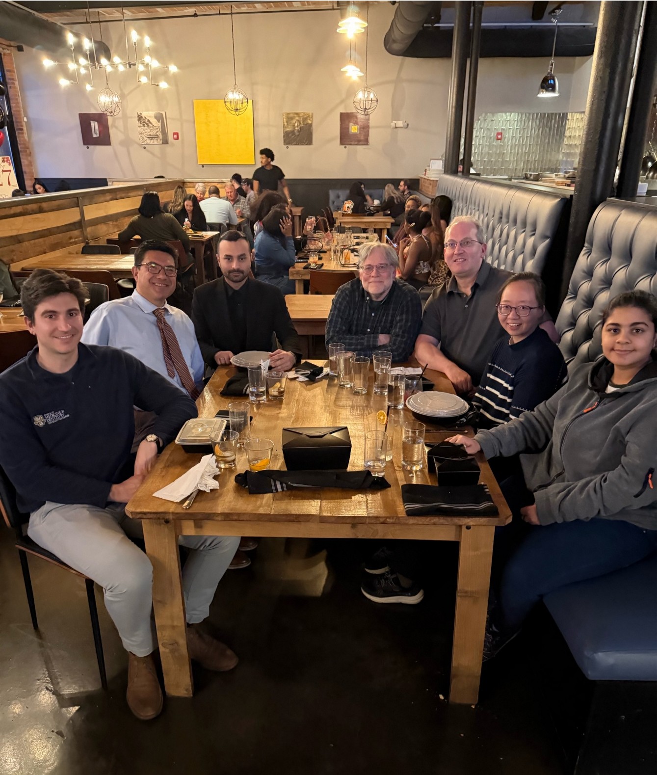 Group photo included Dr. Sadqi Nezhad sitting at a table