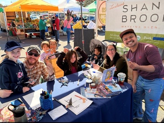 Individuals posing at the lab's table attending the Brighton Farmer's Market
