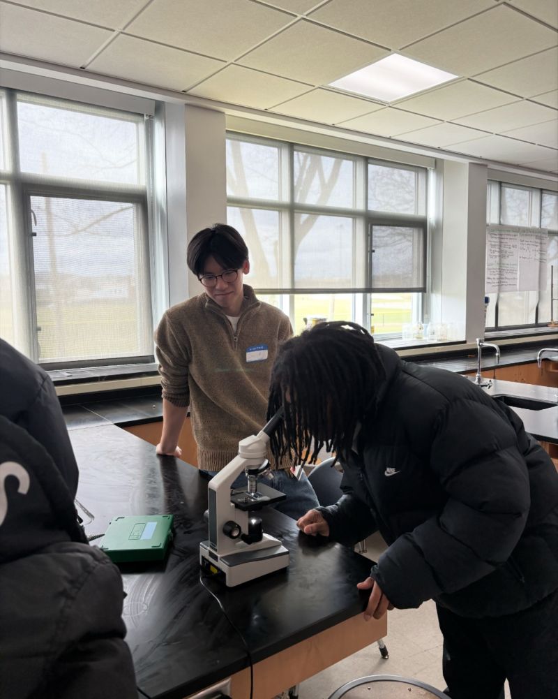 East High student using a microscope