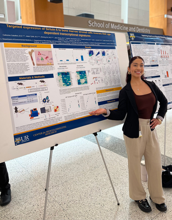 Catherine Caballero in front of the winning poster