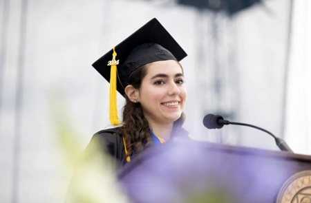 undergraduate biochemistry student delivering address at commencement