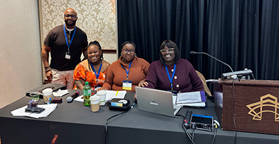 Group of people presenting at a conference