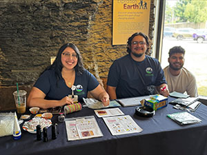 Members of the DeLouise Lab sitting at a table at the Rochester Museum and Science Center