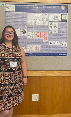 Abby in front of poster
