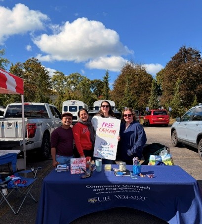 Lab member's posing at their event table